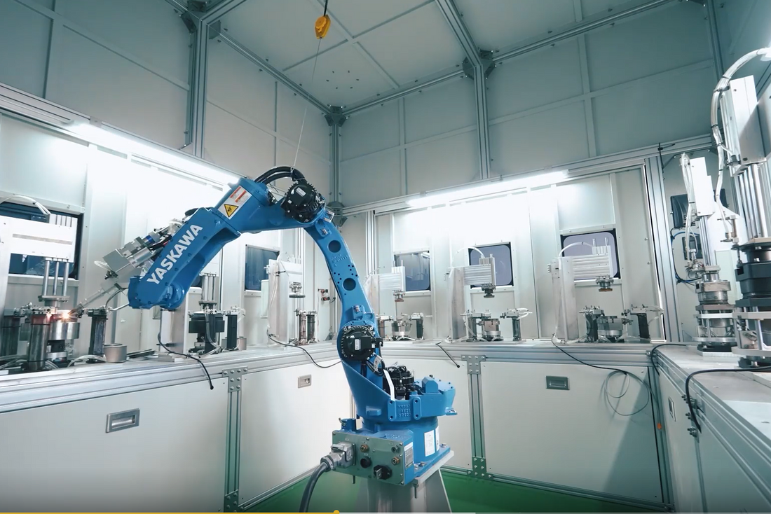 Automated robotic arm manufacturing premium titanium outdoor cookware at the Boundless Voyage factory.