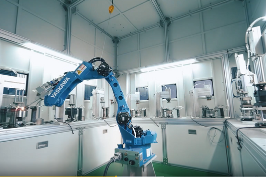 Automated robotic arm manufacturing premium titanium outdoor cookware at the Boundless Voyage factory.