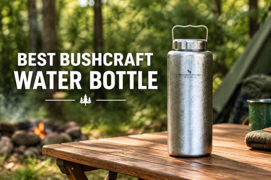 Titanium bushcraft water bottle on a wooden camp table in a forest