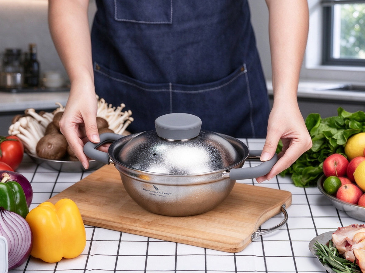 Carrying hot Boundless Voyage 1.2L titanium pot using silicone anti-scald handle grips to dining table