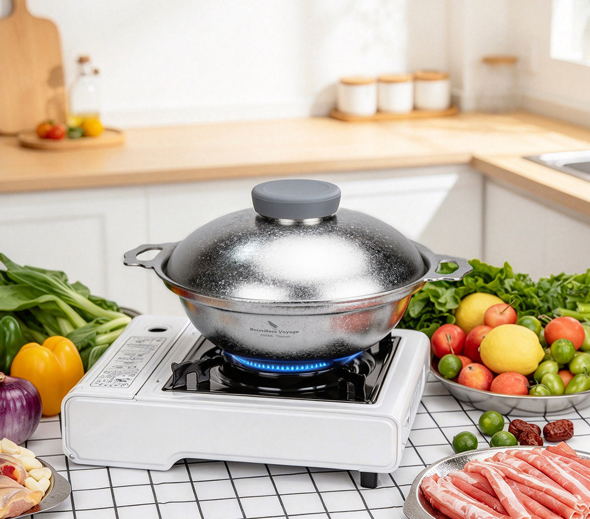 Flat bottom titanium pot heating evenly over blue gas stove flame