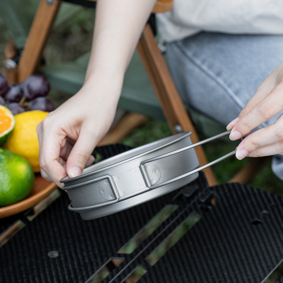 Ti2053C titanium pan frying food over outdoor flame