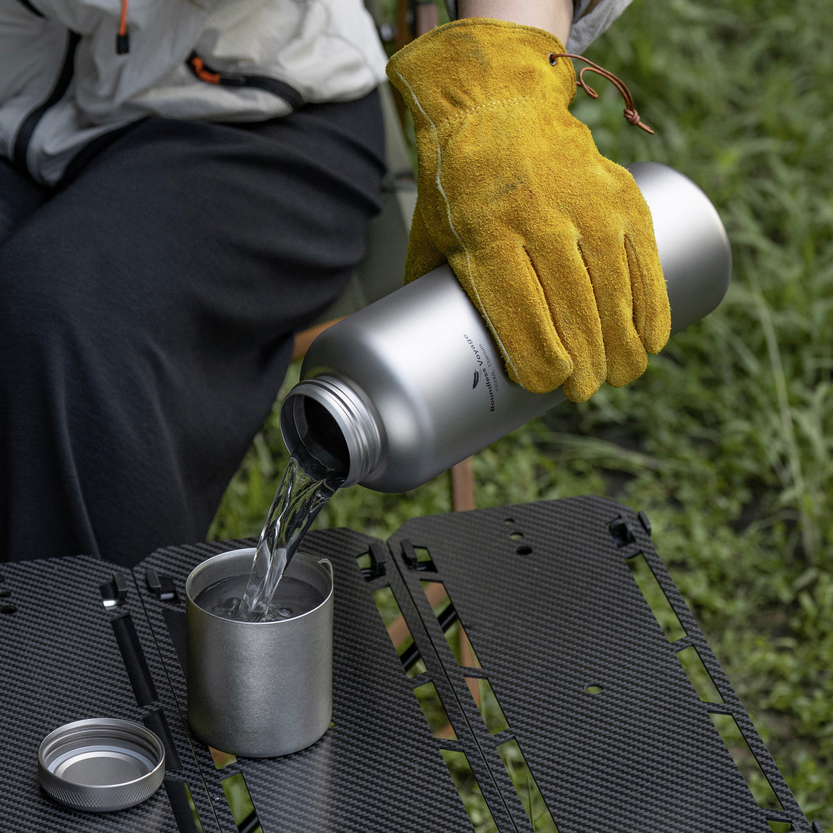 Titanium water bottle carried securely in hiking backpack side mesh pocket