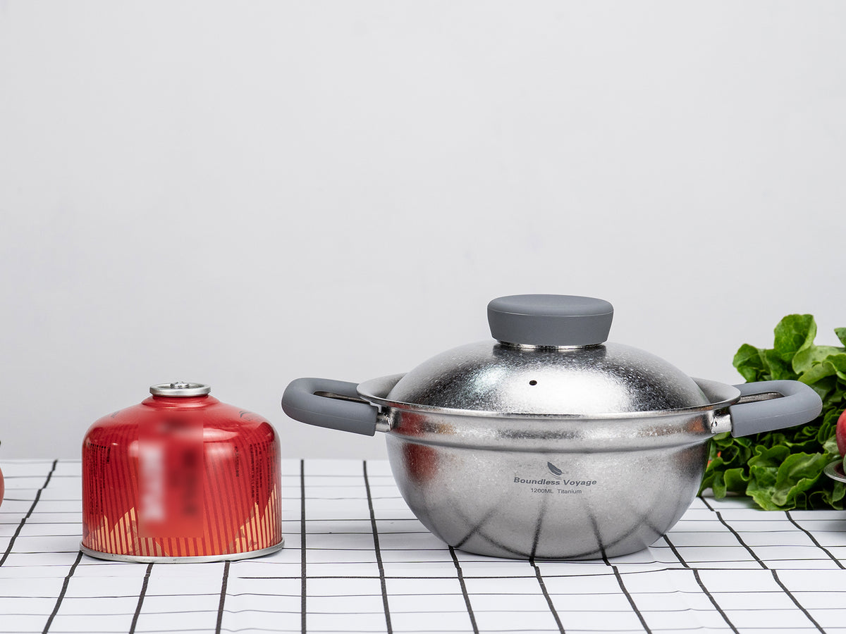 Size comparison between Boundless Voyage 1.2L titanium cooking pot and camping gas canister