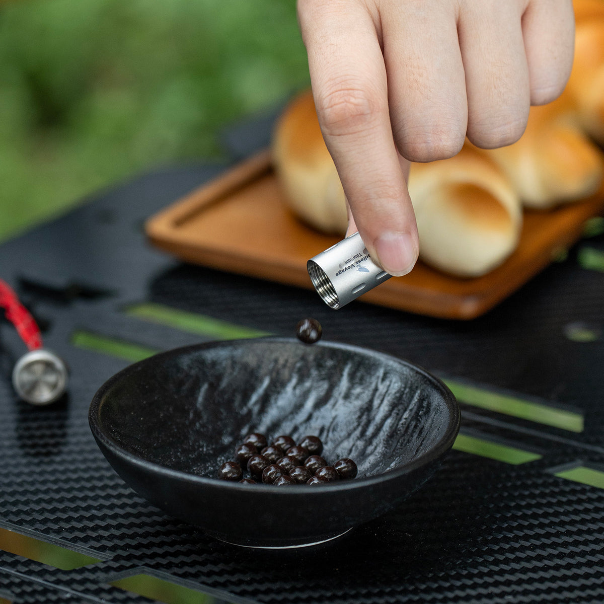 Pouring daily pills from Ti9009A titanium waterproof container into small bowl