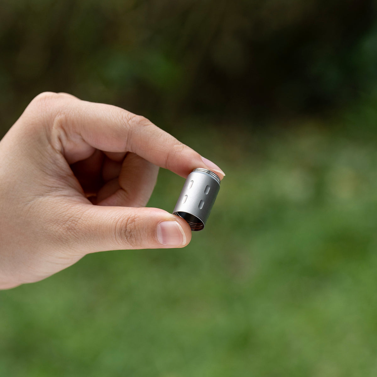 Holding ultralight 5.5g titanium modular extension compartment Ti9009C in hand